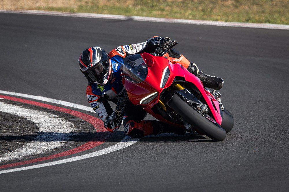2025 Ducati Panigale V2 coming toward camera through a right hand turn on a race track.