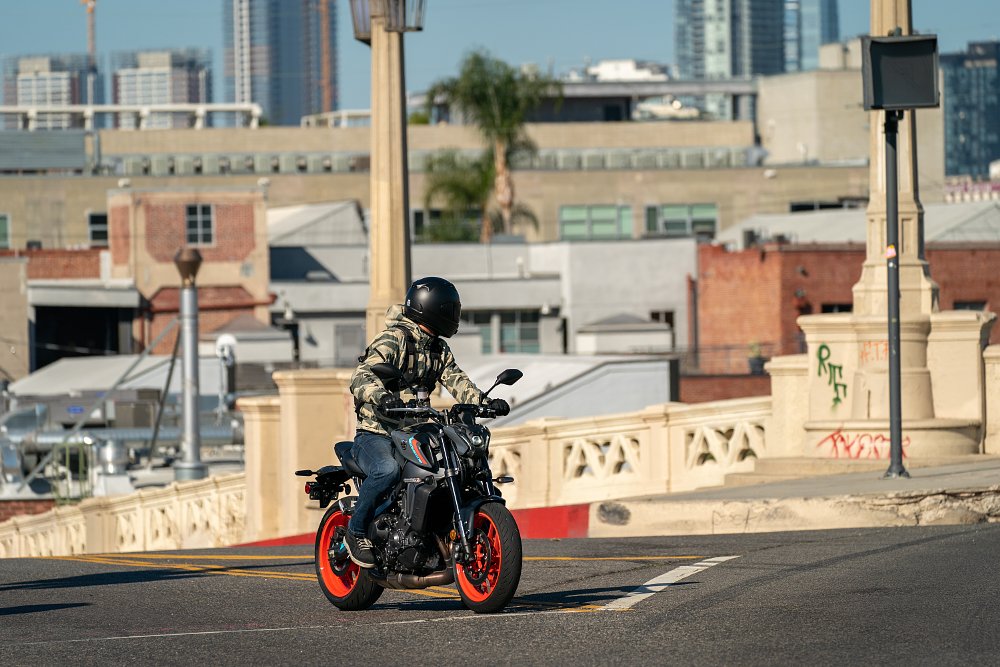 2021 Yamaha MT-09 sits at a stop sign in a city