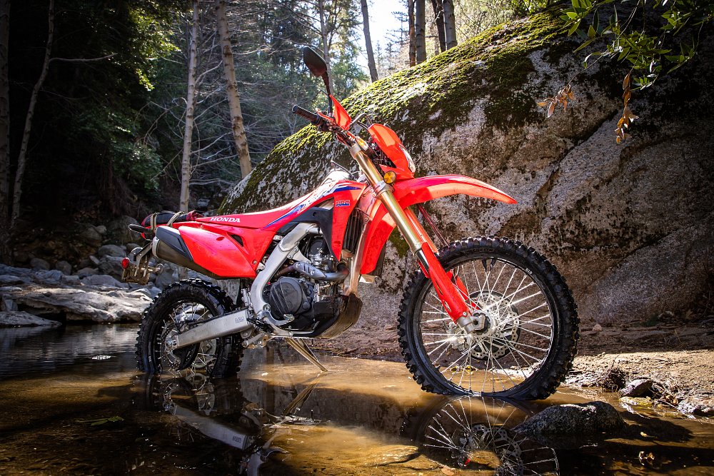 CRF450RL parked in a creek.
