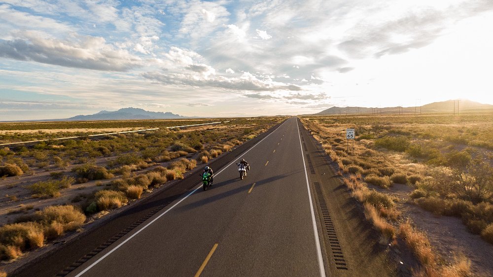 two motorcycles on an open desert road