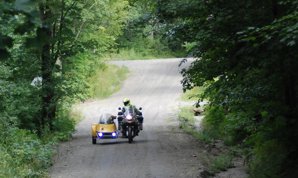 Barley and Burke coming home in the motorcycle and sidecar
