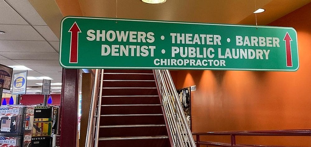 sign for theater, barber shop, dentist and more inside of the Iowa 80 truck stop
