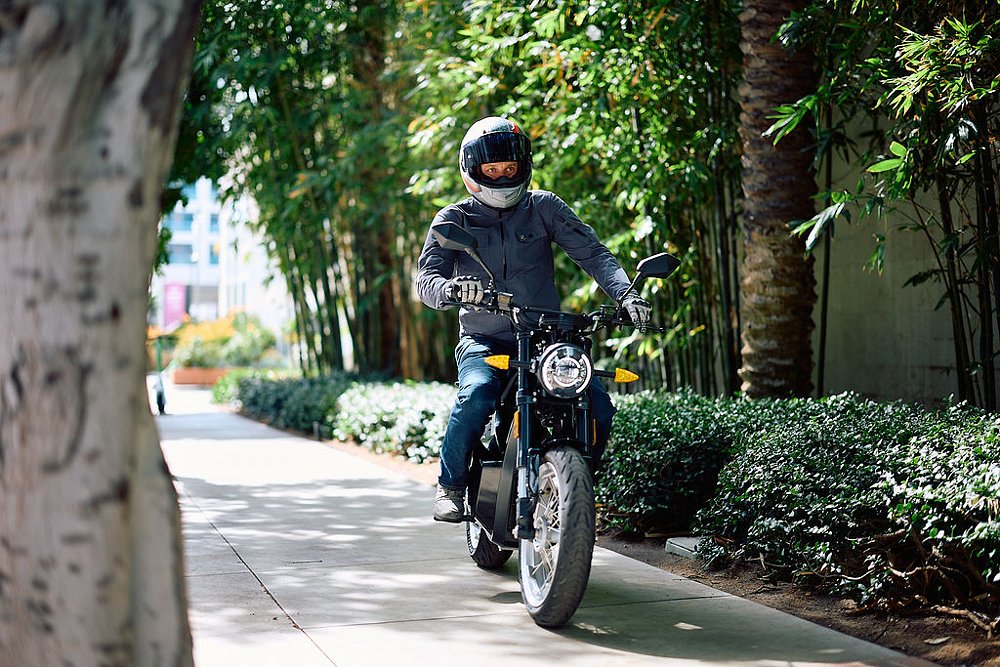 Sondors MetaCycle being ridden slowly on an empty sidewalk