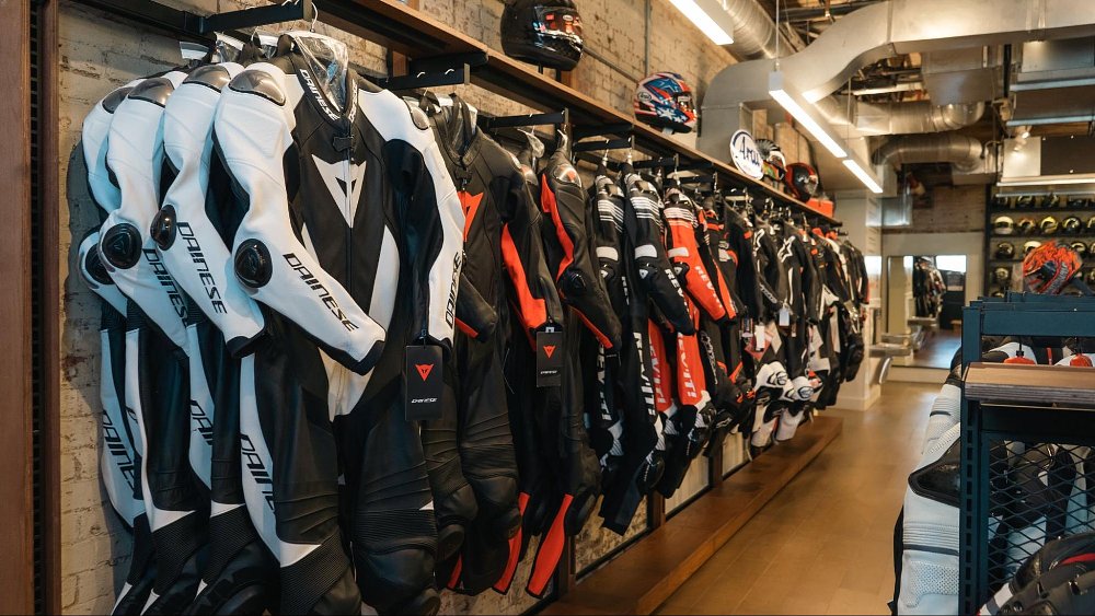 a photo inside Revzilla Brooklyn store of a rack of leather suits