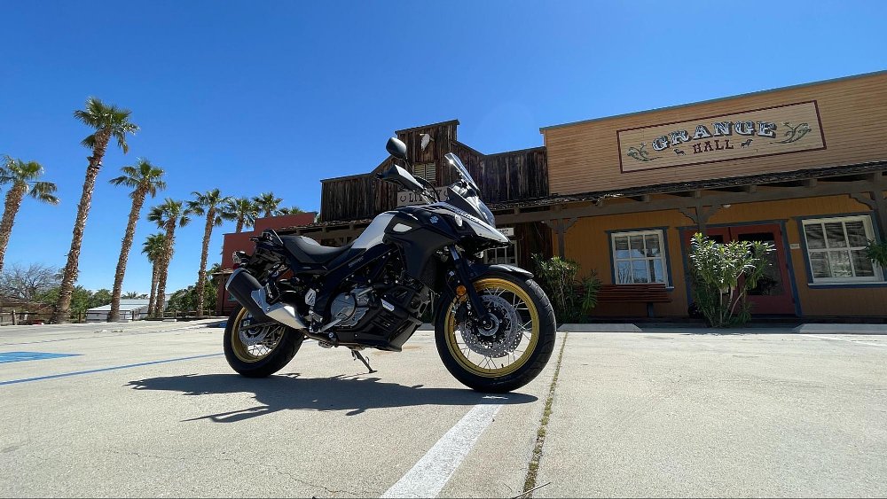 A side profile of V-strom in parking lot