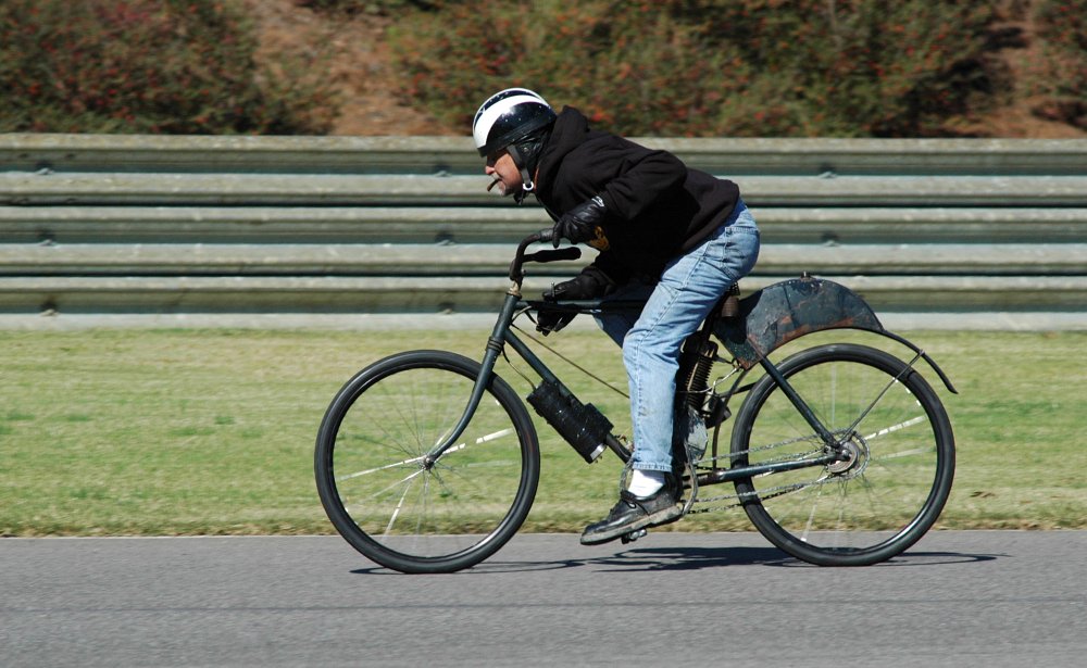 Walksler racing with a cigar clenched in his teeth