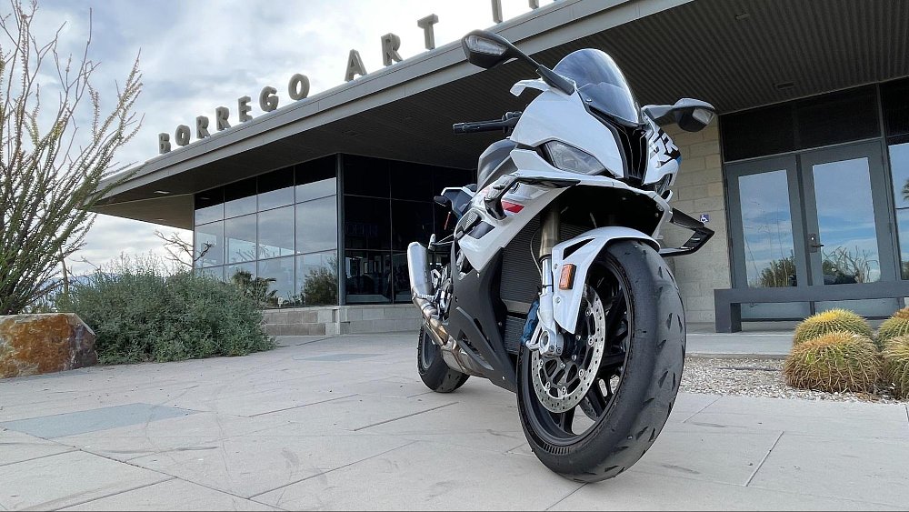 A front view of the BMW s 1000 rr parked in front of a modern art museum