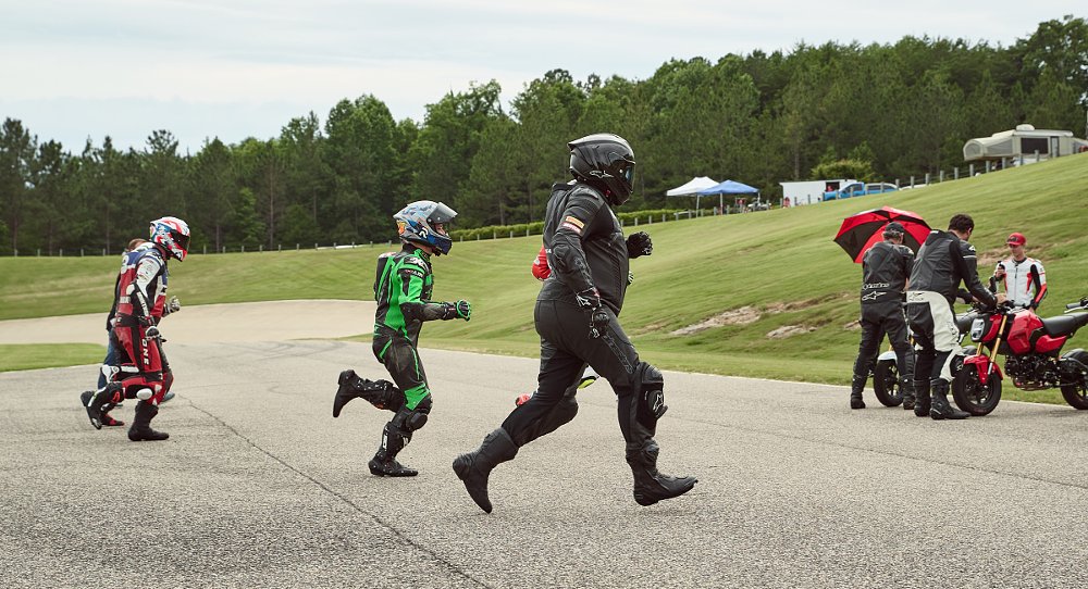 riders in leathers running to their motorcycles