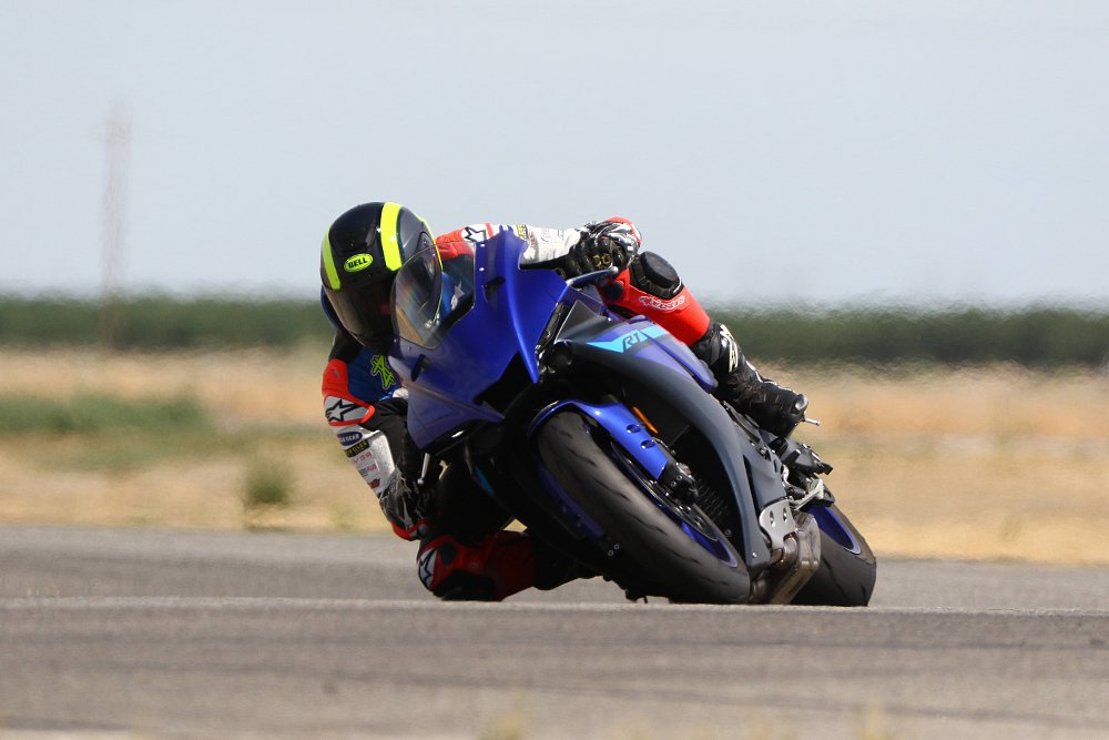 A 2024 Yamaha R1 navigates a right hand corner at Buttonwillow Raceway in California.