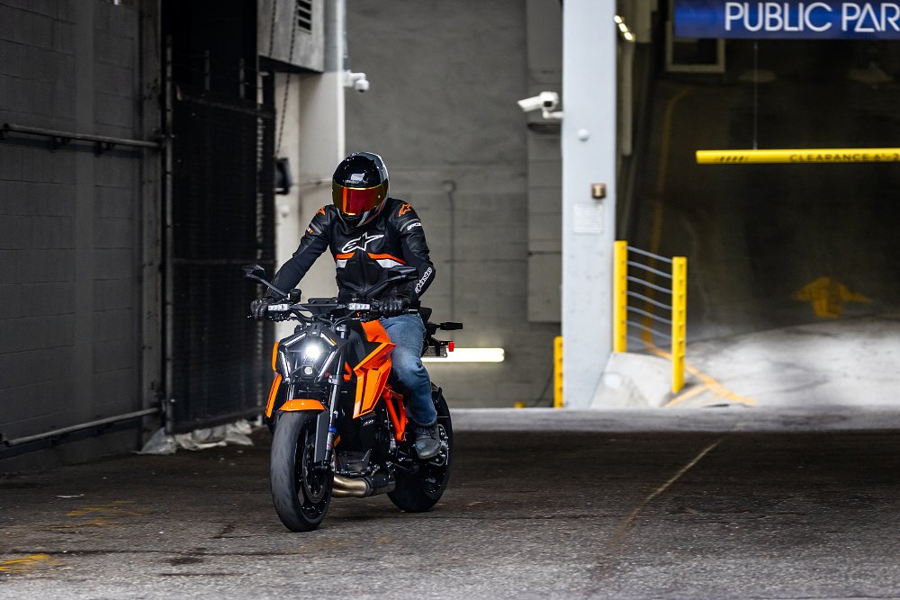 A KTM 1390 Super Duke R riding out of a parking garage in downtown Los Angeles.