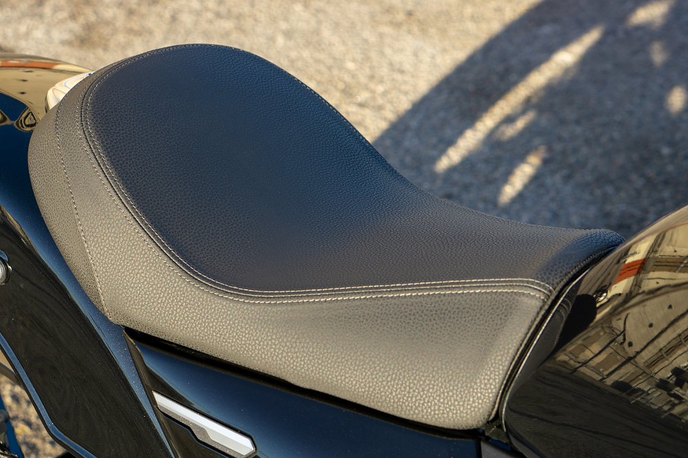 The R12's solo seat is wrapped in pebbled leather and tonal stitching.