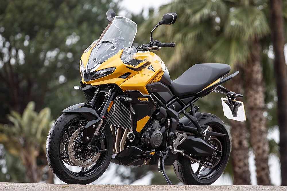 The 2025 Triumph Tiger Sport 800, in Cosmic Yellow paint, pictured before palm trees.