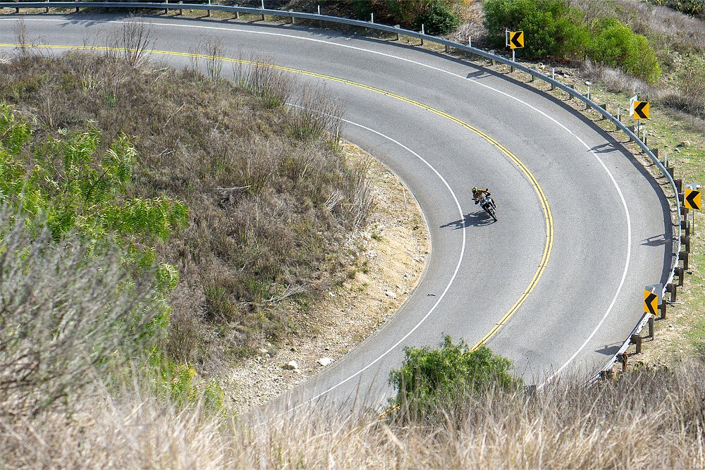 Dustin and the CFMOTO Ibex 450 go around a hairpin turn.