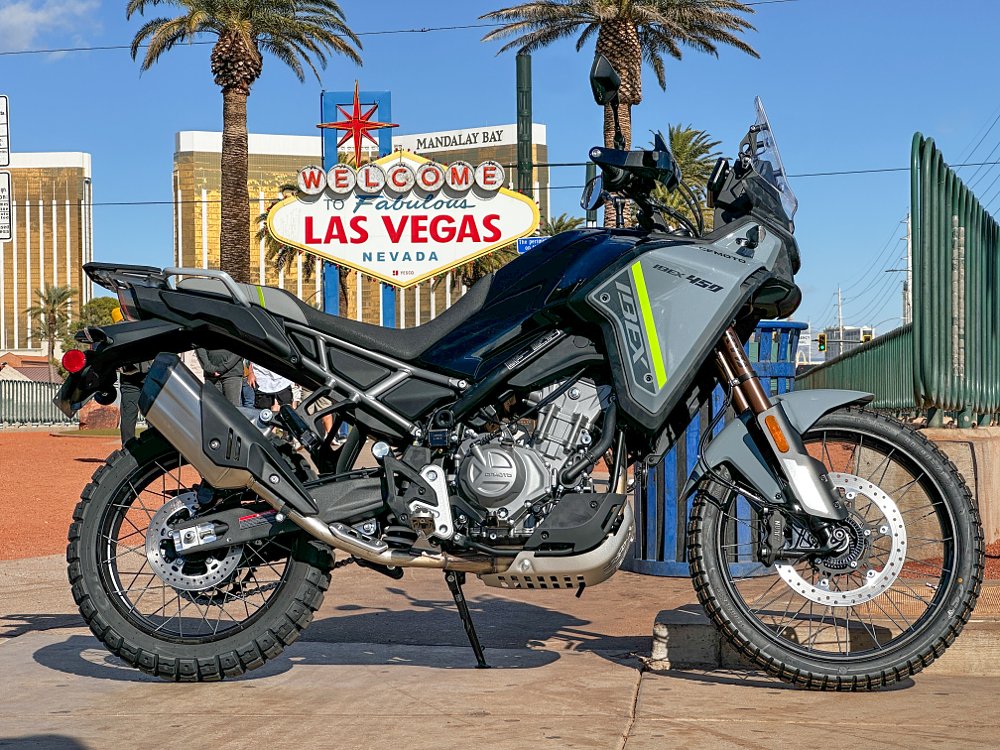 The CFMOTO Ibex 450 parked before the Welcome to Fabulous Las Vegas sign.