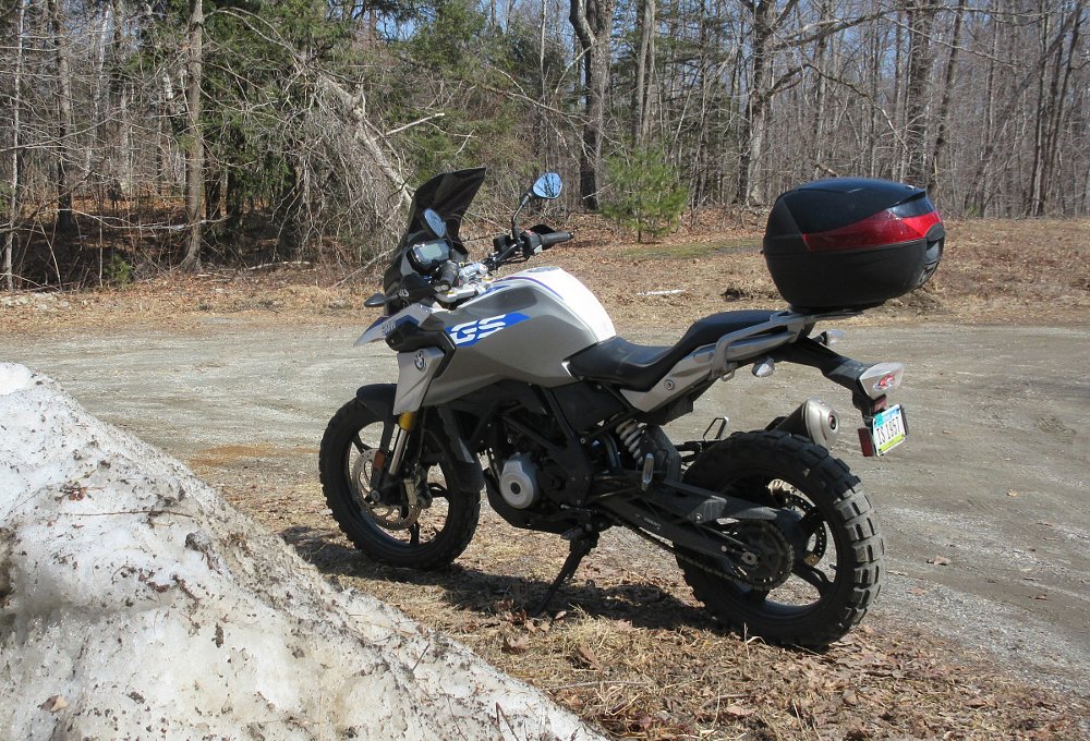 BMW G 310 GS parked by a pile of dirty snow