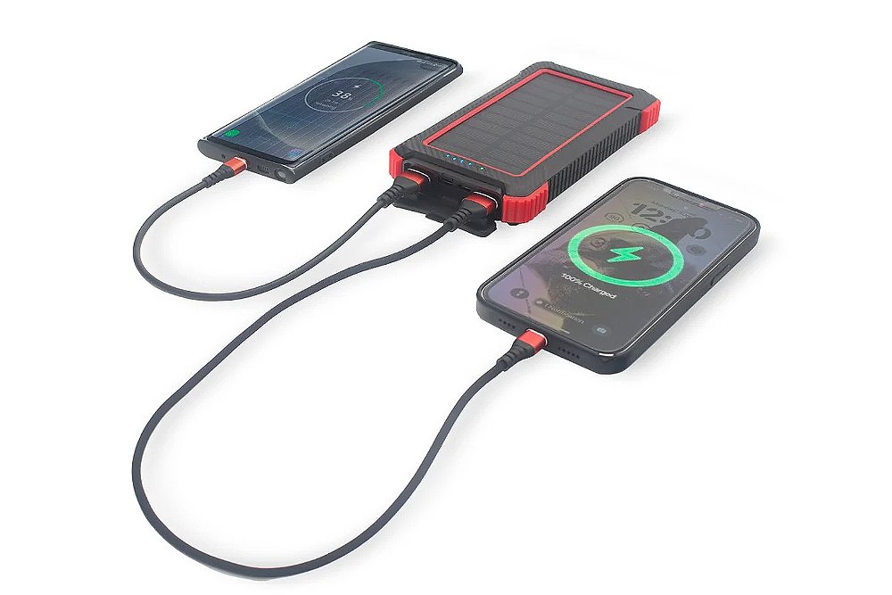 Two smartphones charge on a RidePower external battery pack.