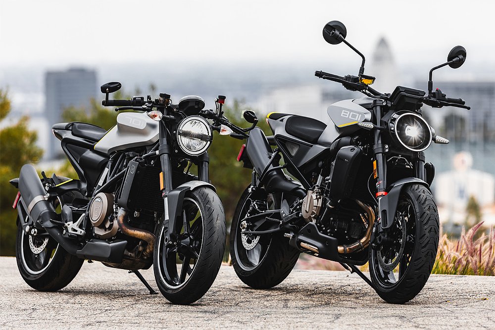 The Husqvarna Vitpilen 801 and 701 staged side-by-side on a mountain overlooking Los Angeles.