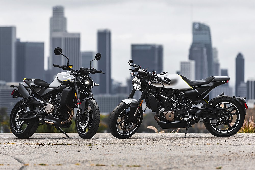 The Vitpilen 801 and 701 standing nose-to-nose with the Los Angeles skyline in the background.